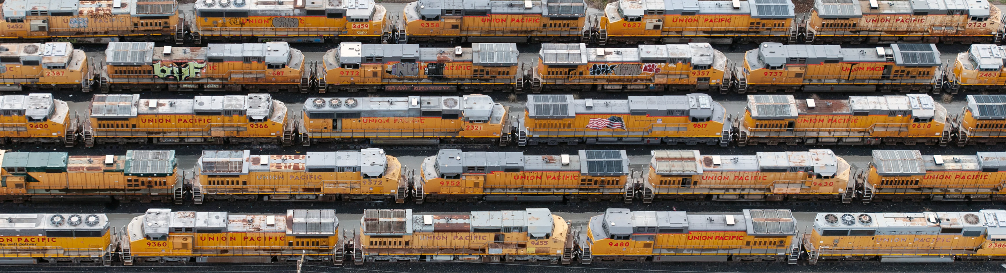 Rows of freight railcars arranged across a rail yard