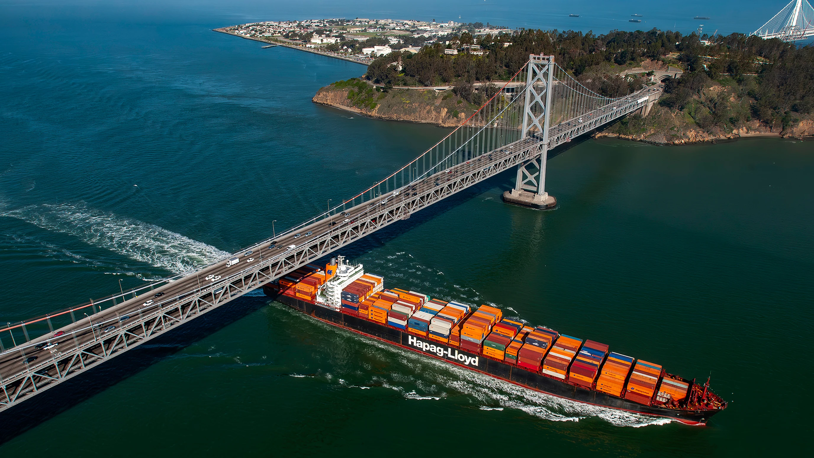 Container ship passing beneath the San Francisco-Oakland Bay Bridge